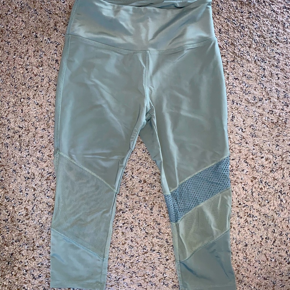 Olive cropped workout leggings with mesh panels.